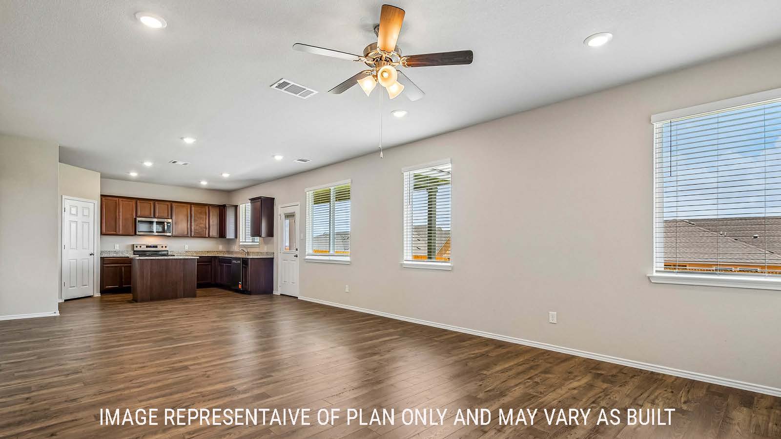 Prosper dining room with view of open concept kitchen and windows for natural lighting.