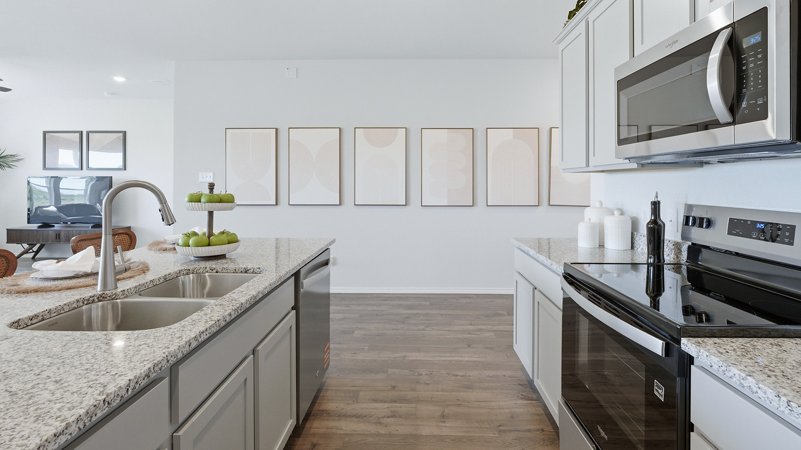 Eagles Landing Model Home kitchen with light cabinets and granite countertops.