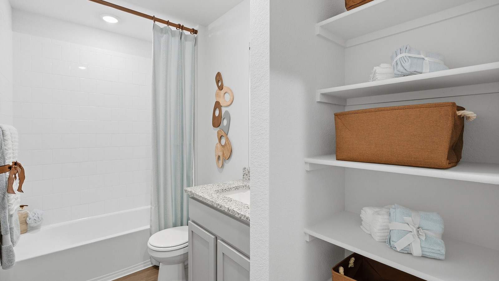 Eagles Landing Model Home secondary bathroom with single vanity sink and shower and tub combo.