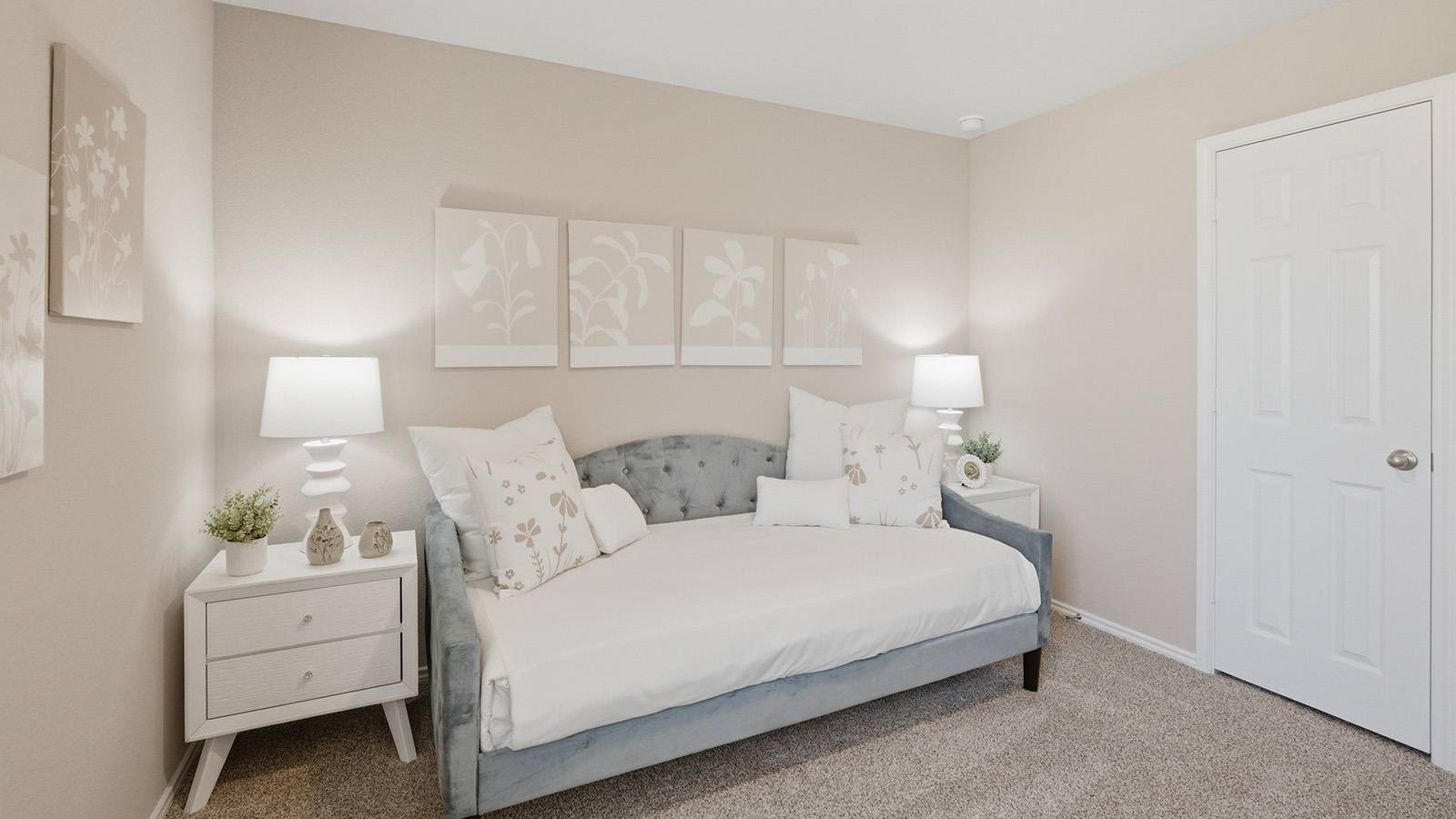Eagles Landing Model Home secondary bedroom with carpeted flooring and bed and couch combo.