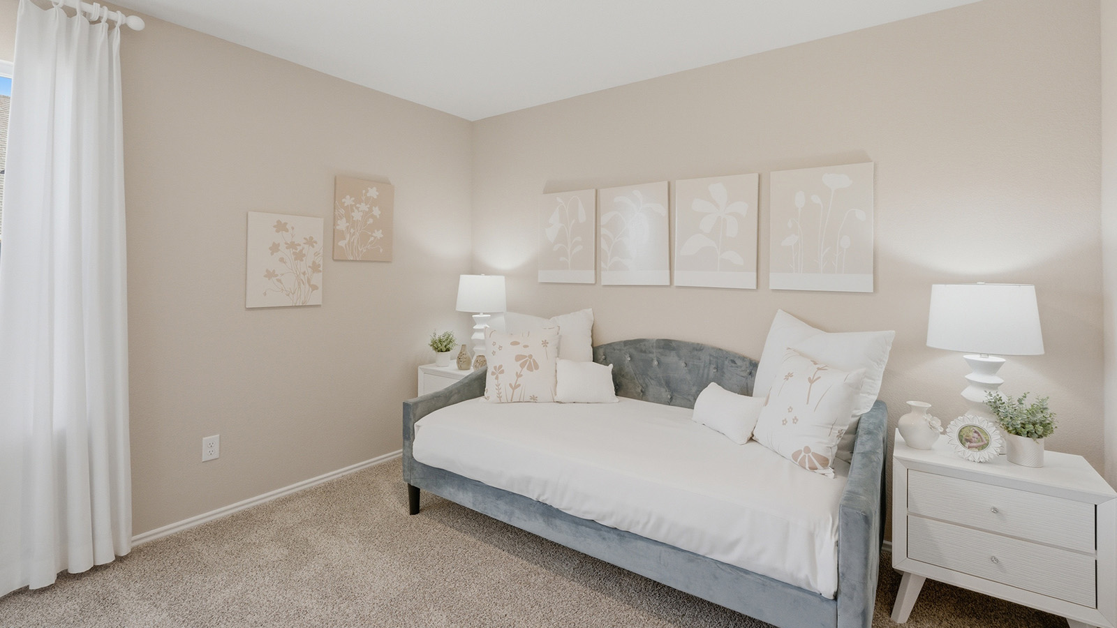 Eagles Landing Model Home secondary bedroom with carpeted flooring and bed and couch combo.