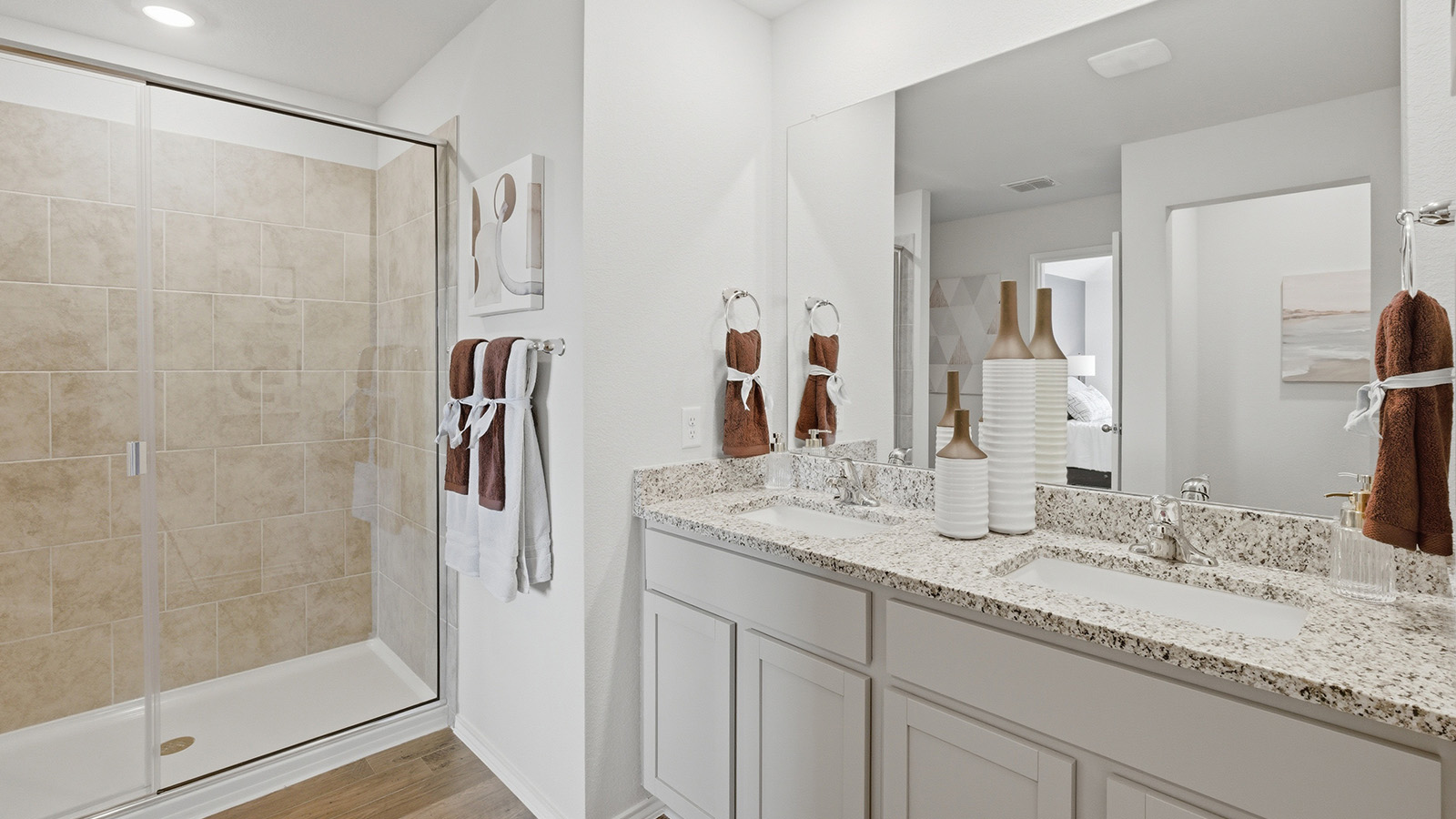 Eagles Landing Model Home primary bathroom with double vanity sink and walk-in shower.