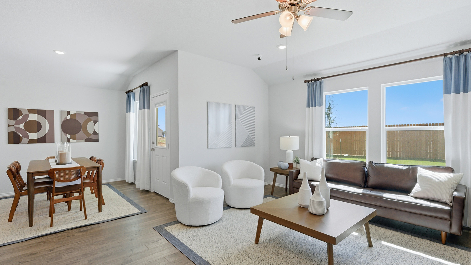 Eagles Landing Model Home living room with windows for lighting and view of open concept dining room.