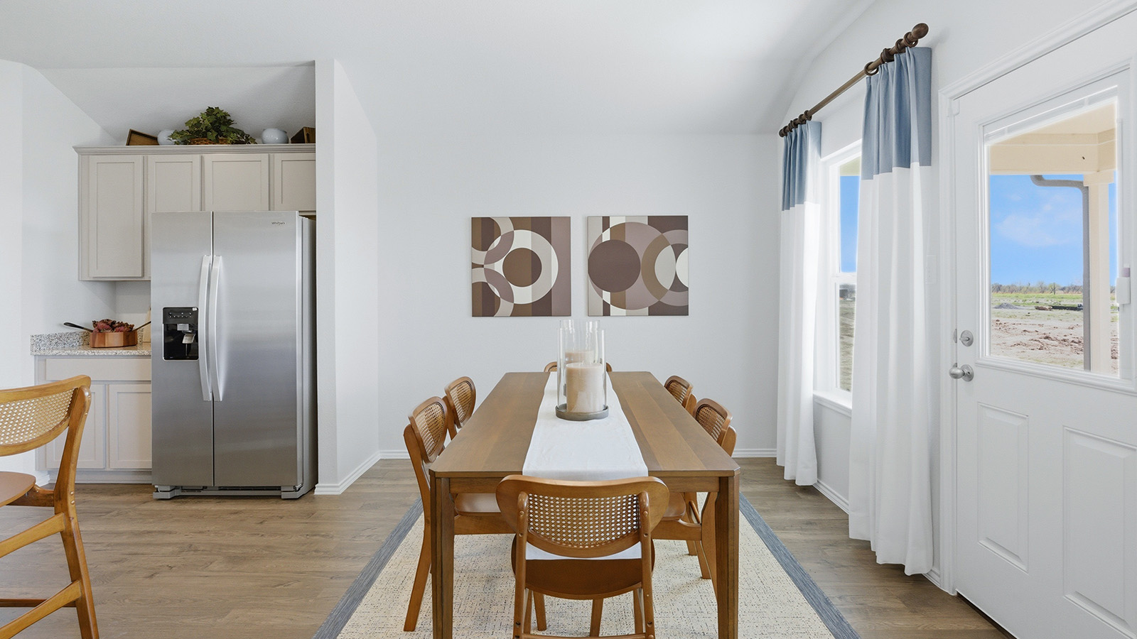 Eagles Landing Model Home dining room with dining room table and view of back door and view of back yard.