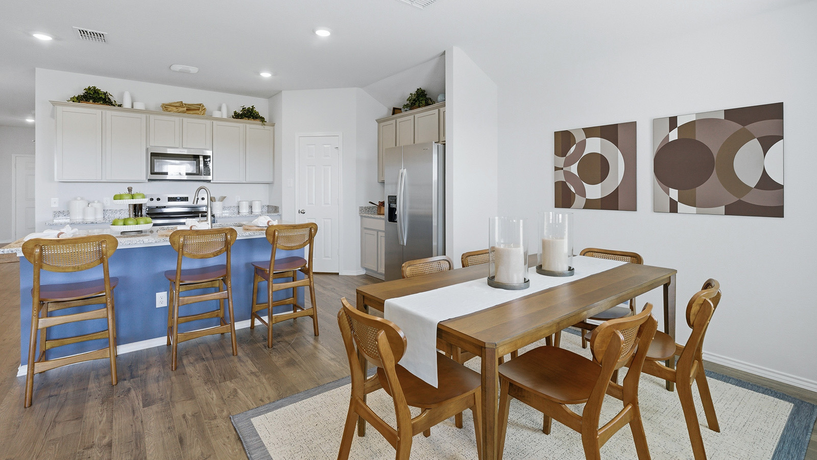 Eagles Landing Model Home dining room with dining room table and view of open concept kitchen.