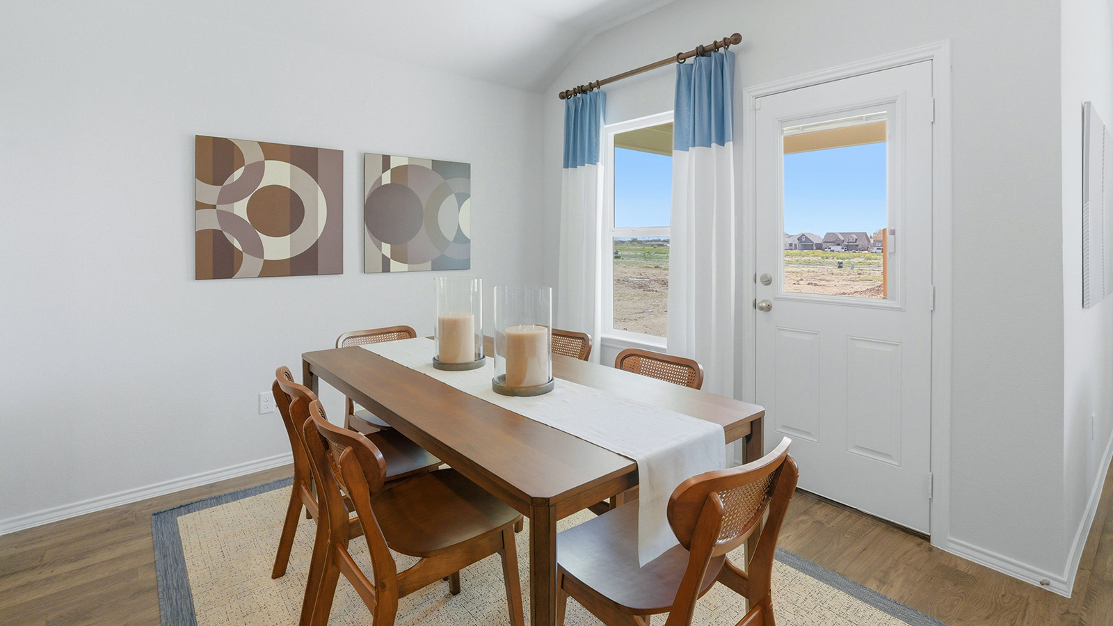 Eagles Landing Model Home dining room with dining room table and back door and view of back yard.