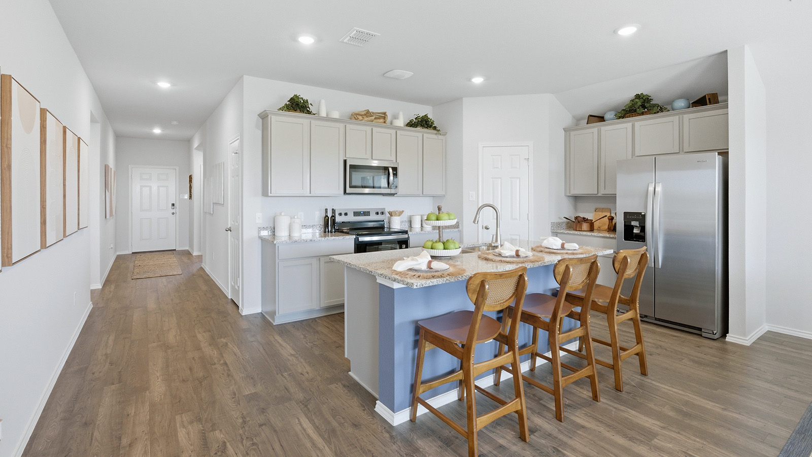 Eagles Landing Model Home kitchen with kitchen island and view of the front hallway and entrance.