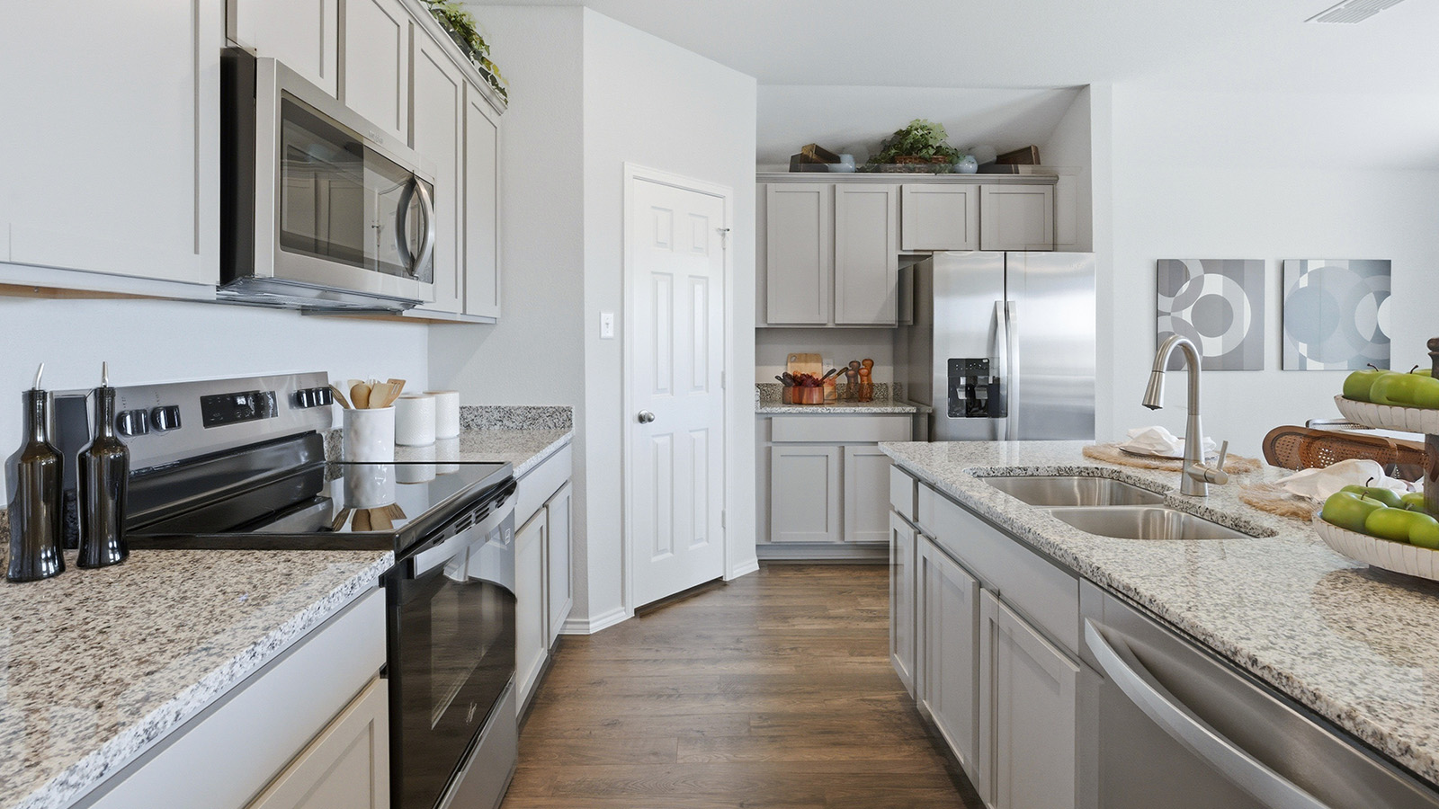 Eagles Landing Model Home kitchen with light cabinets and granite countertops.