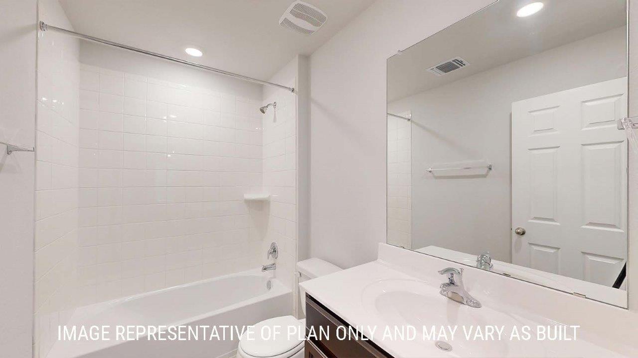 Emma secondary bathroom with vanity sink and bath tub and shower combo.