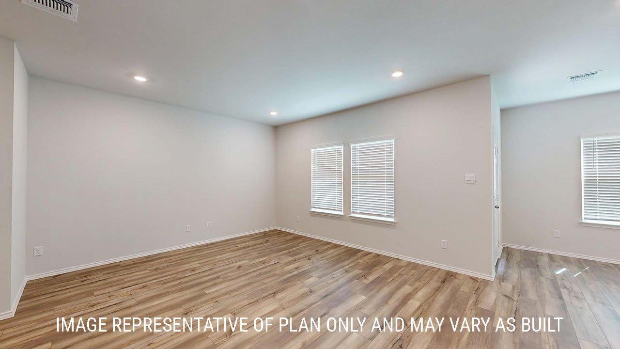 Emma living room with vinyl plank flooring and windows for lighting.