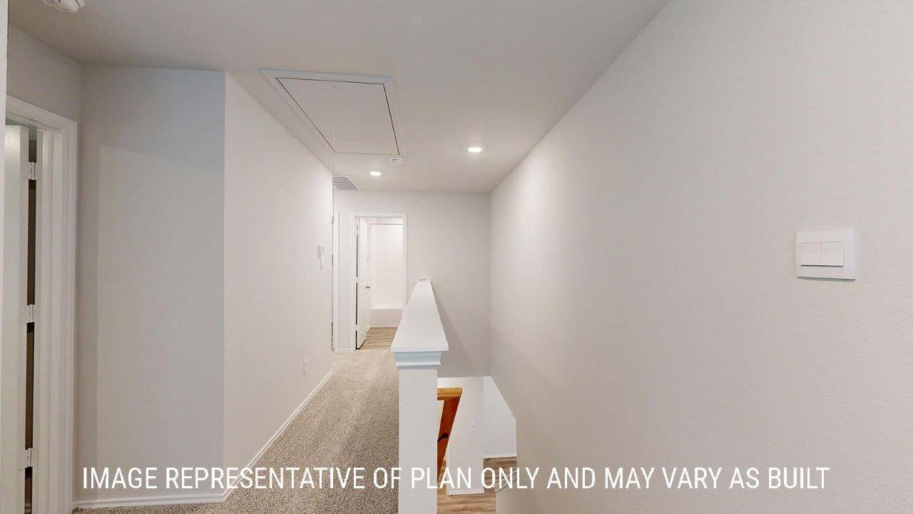 Emma hallway with carpeted flooring and view of secondary bedrooms.