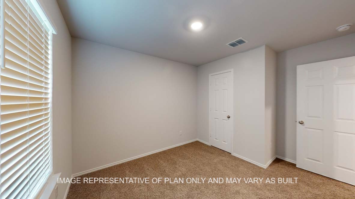 Ashburn secondary bedroom with view to closet door.