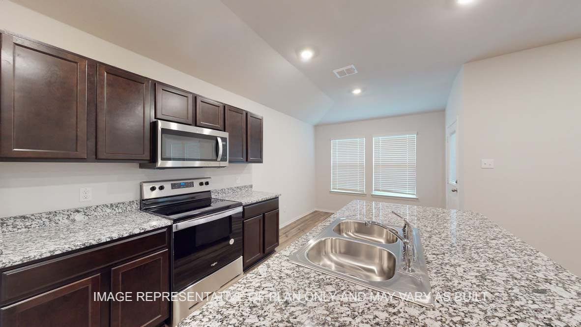 Ashburn kitchen with granite countertops and dark cabinets.