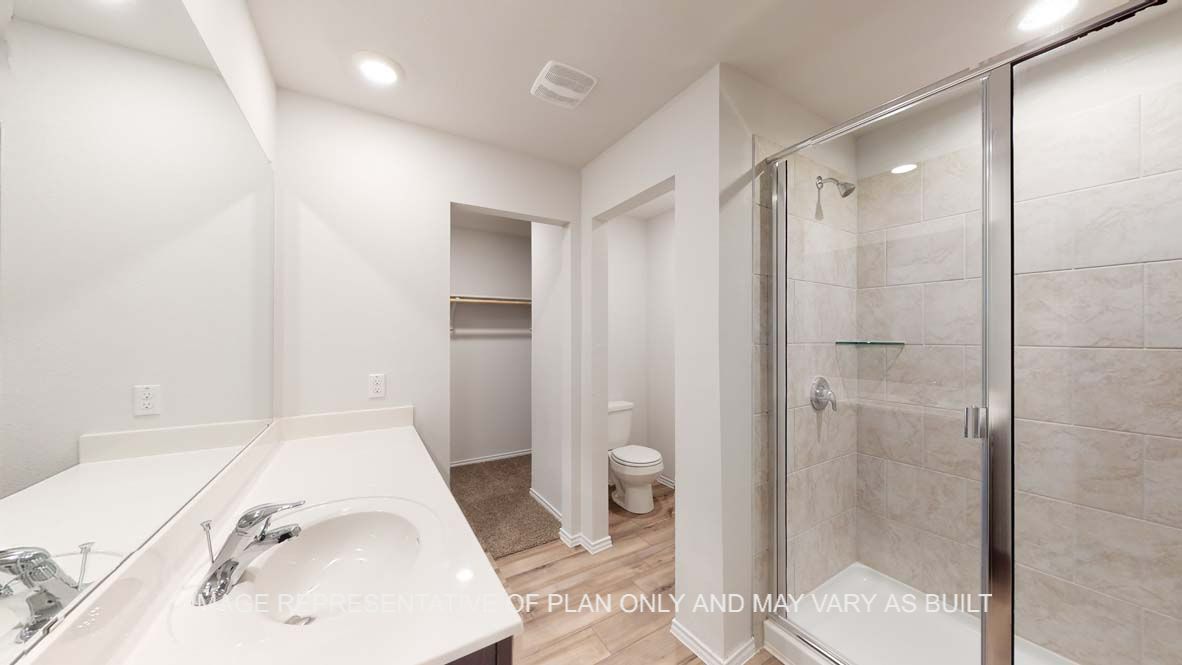 Ashburn primary bathroom with clear shower glass enclosure with ceramic tile shower surround.