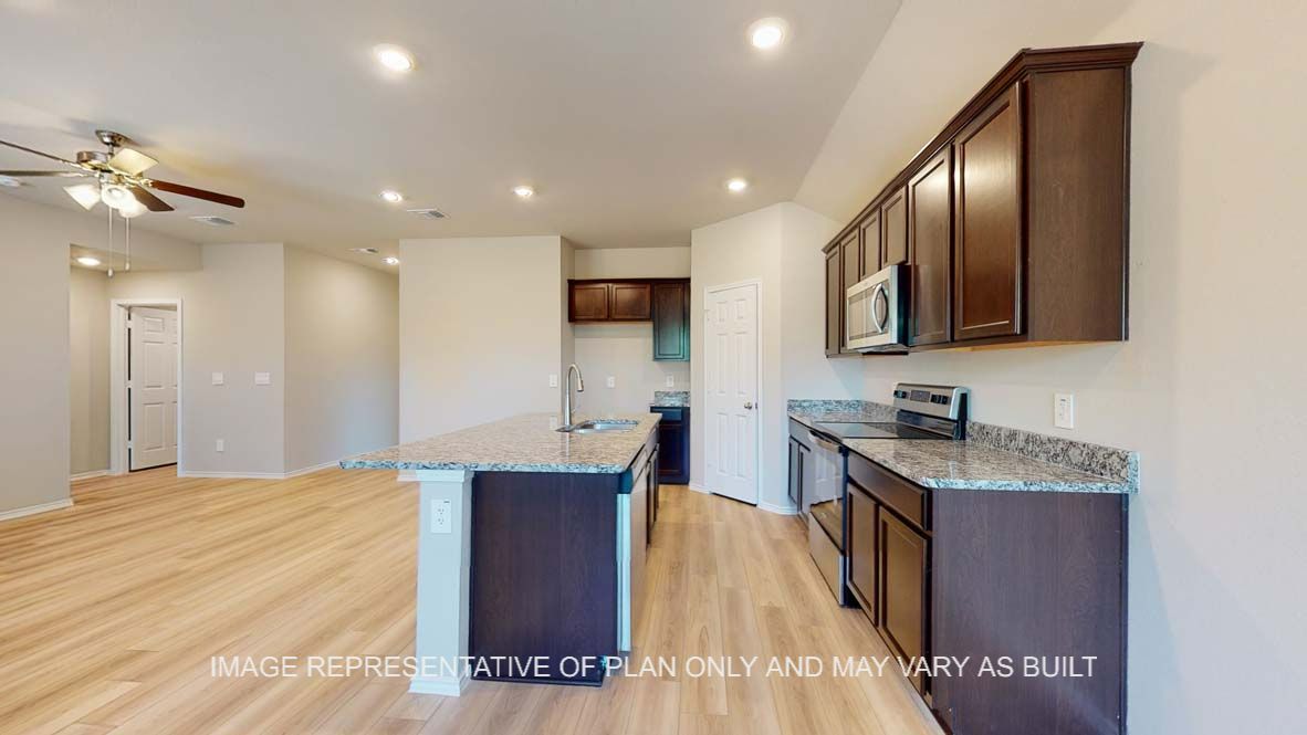 Bellvue kitchen with dark cabinets and granite countertops.