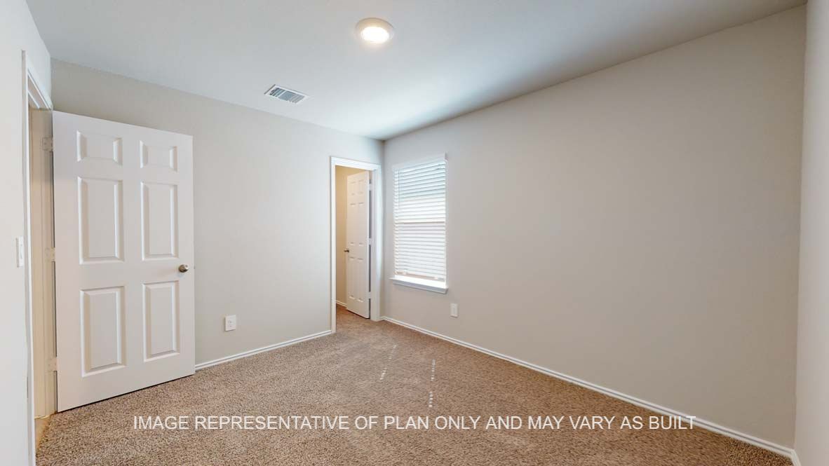 Bellvue secondary bedroom with carpet flooring and window.