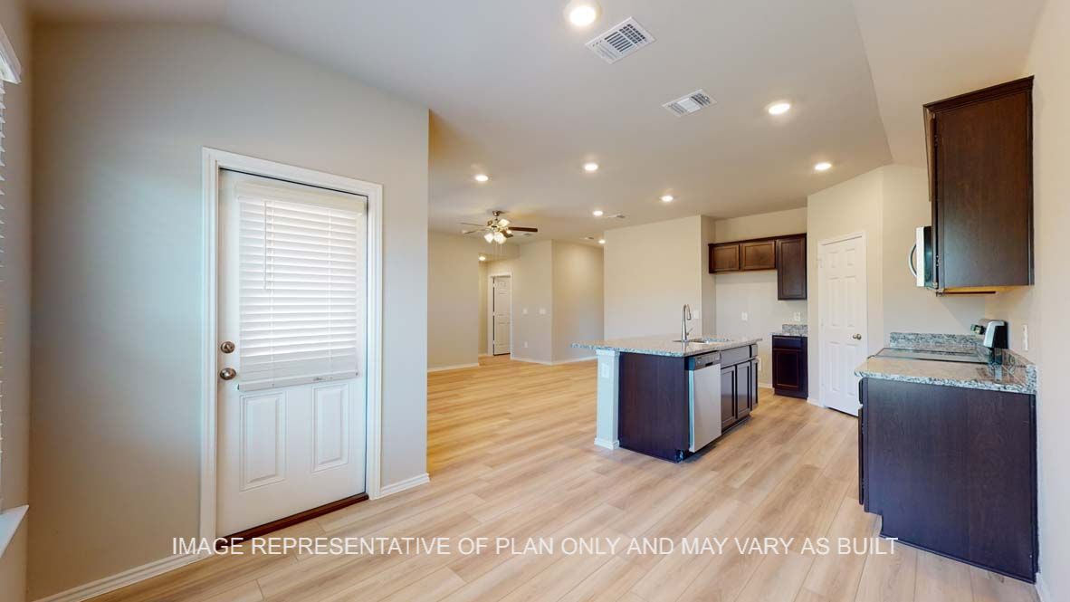 Bellvue dining room with view into kitchen and vinyl plank flooring.