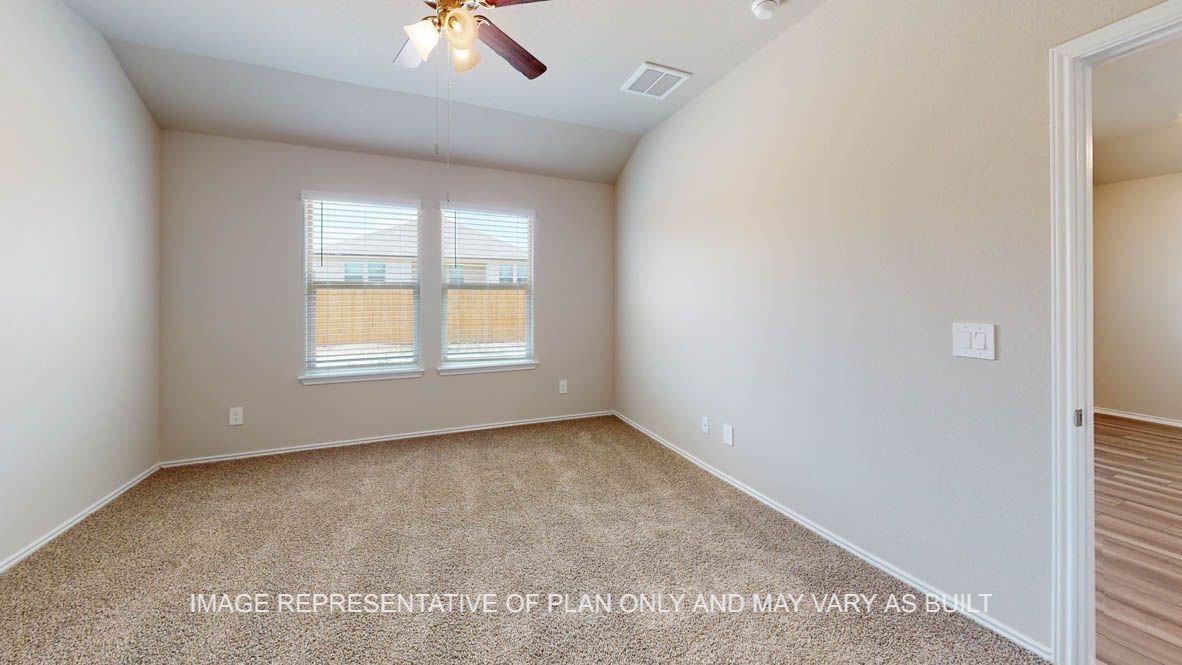 Elgin secondary bedroom with carpet flooring and windows.