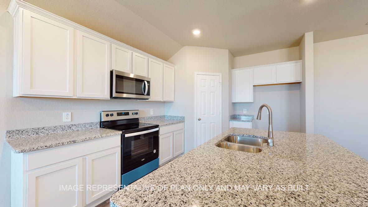 Fargo kitchen with white cabinets and granite countertops.