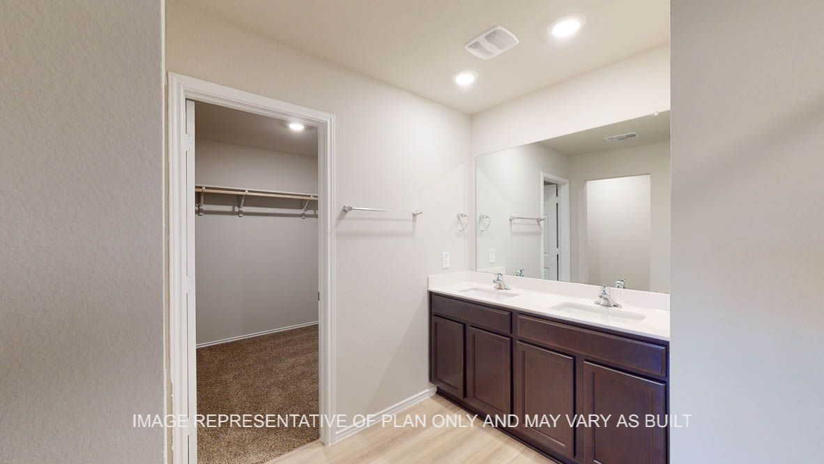Texas Cali primary bath with dark cabinets and white countertops.