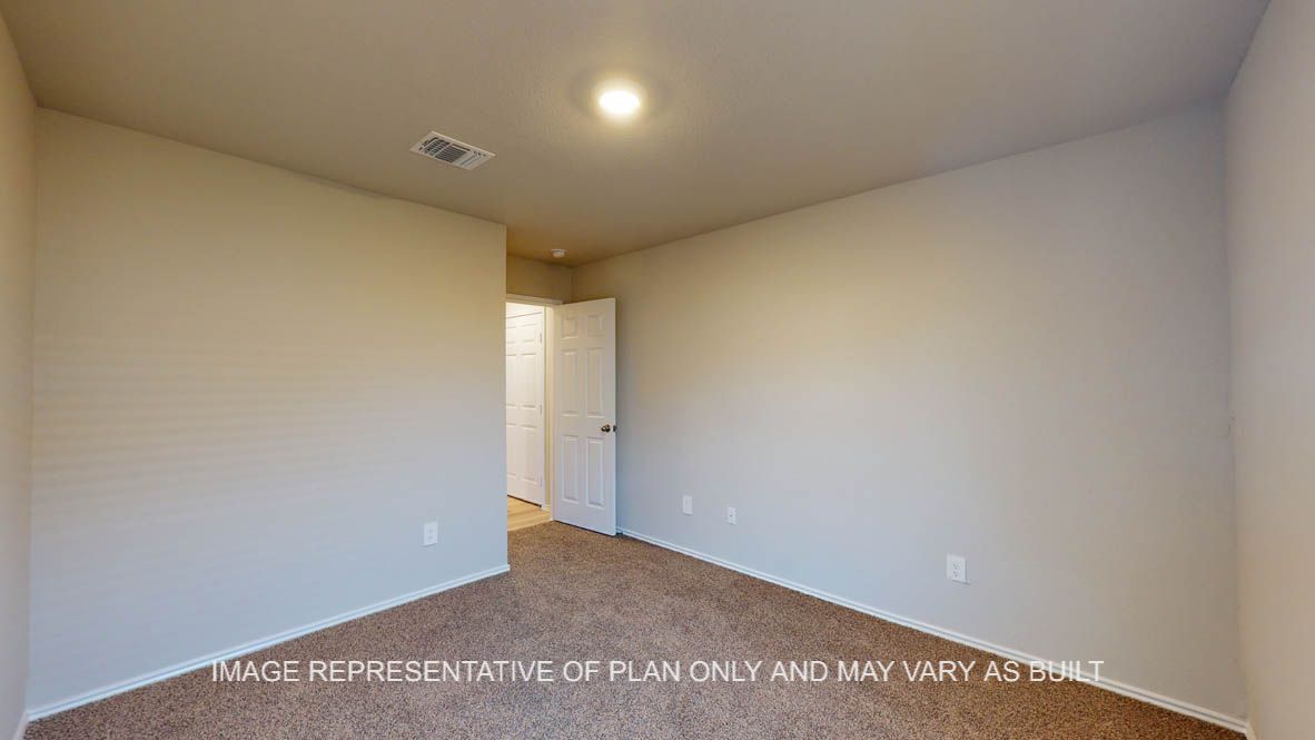 Texas Cali secondary bedroom with carpet flooring.