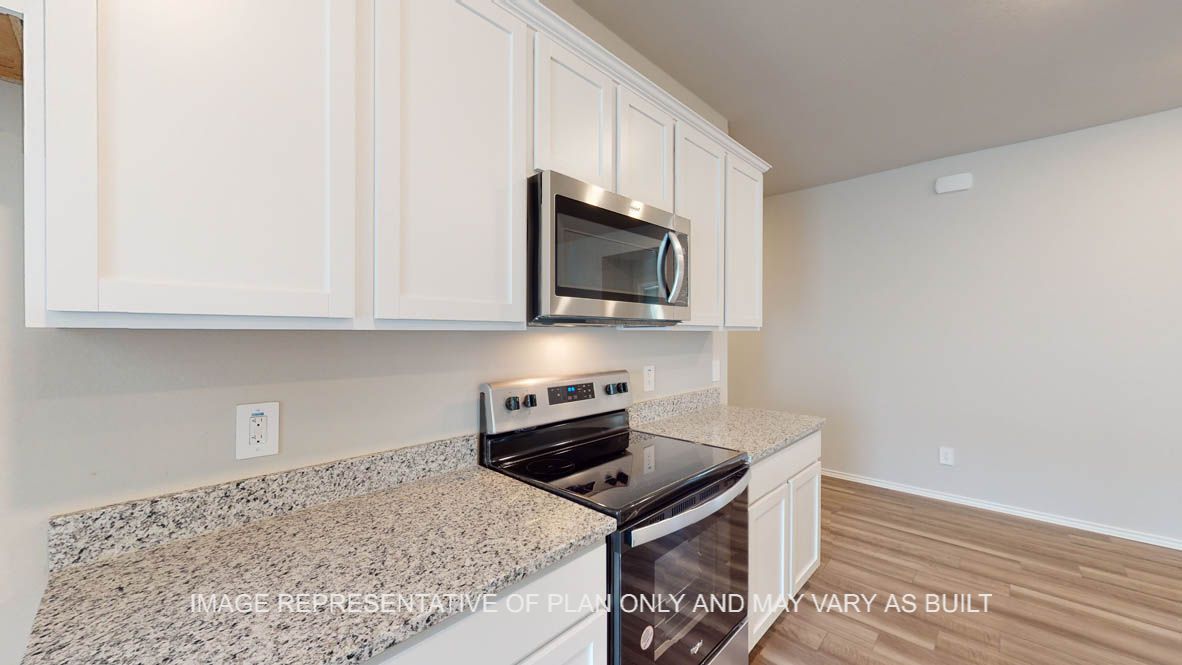 Kingston kitchen with white cabinets and granite countertops.