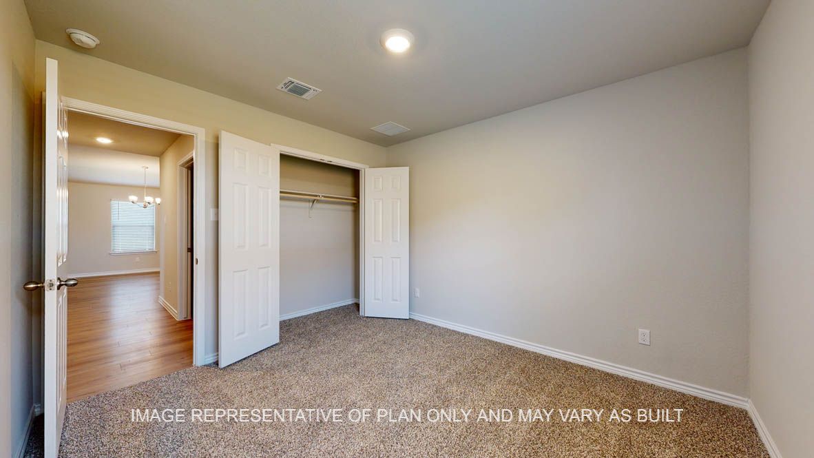 Richmond secondary bedroom with carpet flooring and closet.