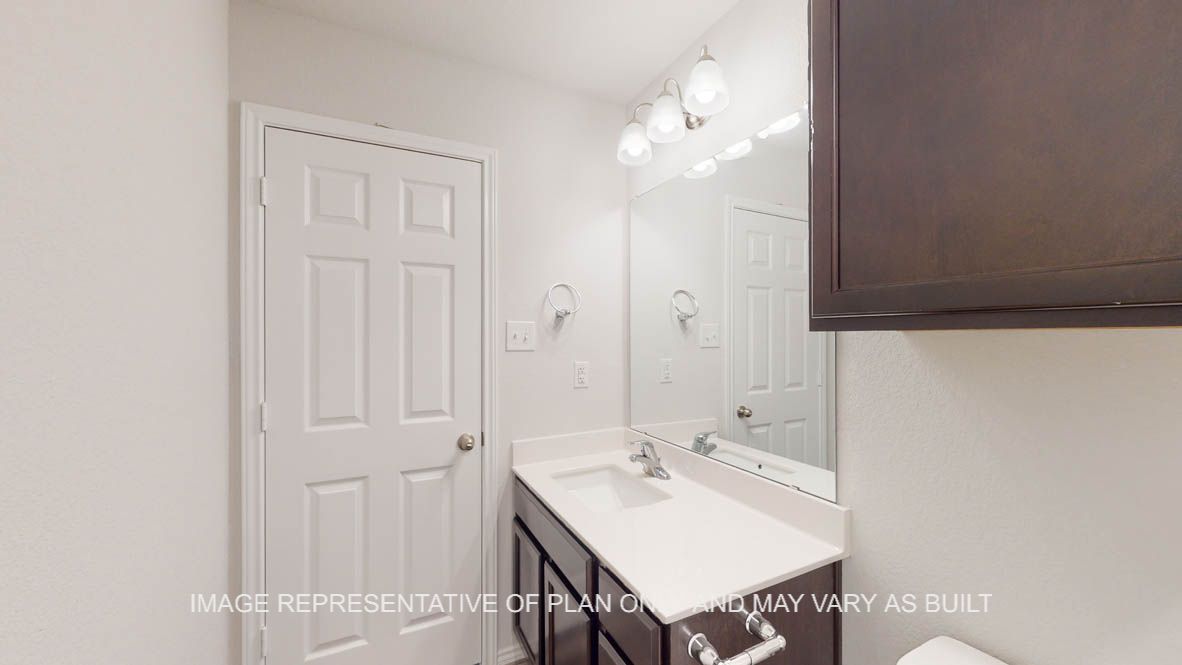 Prescott secondary bathroom with dark cabinets and single vanity.