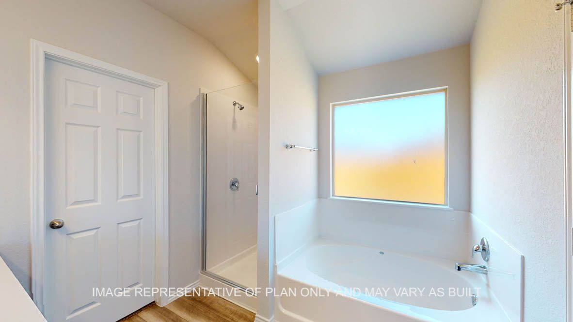 Prescott primary bathroom with vinyl plank flooring and dark cabinets.