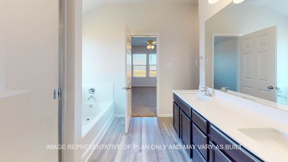 Prescott primary bathroom with dark cabinets and white countertops.