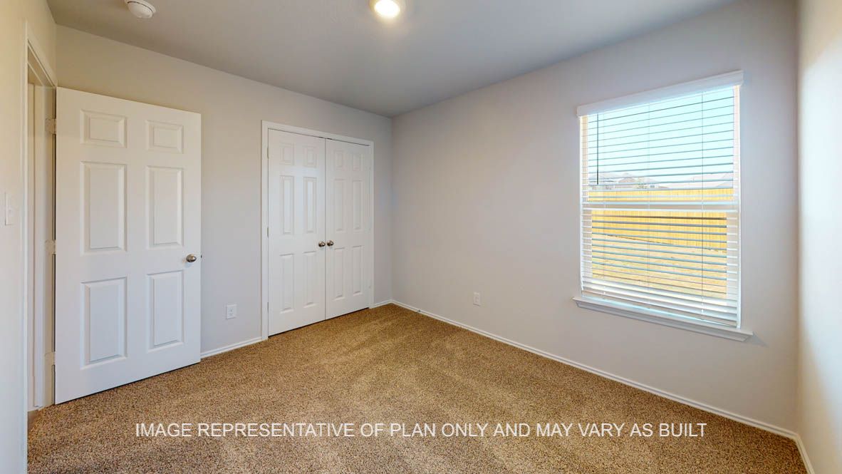 Prescott secondary bedroom with carpet flooring and window.