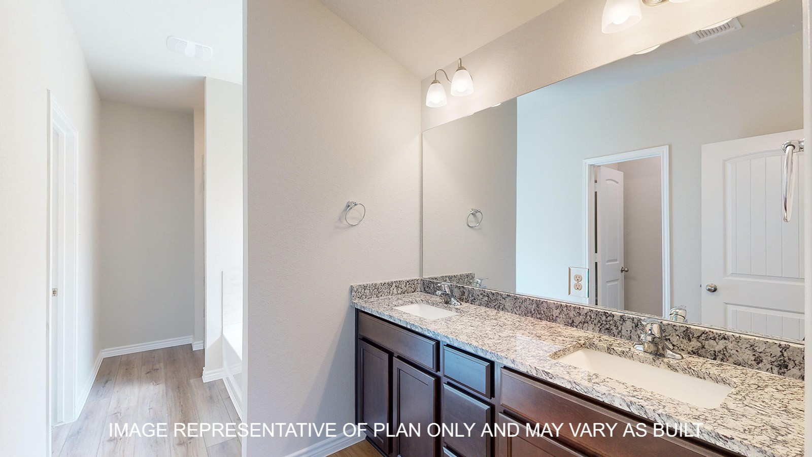 Monroe primary bathroom with granite countertops and dual vanities.