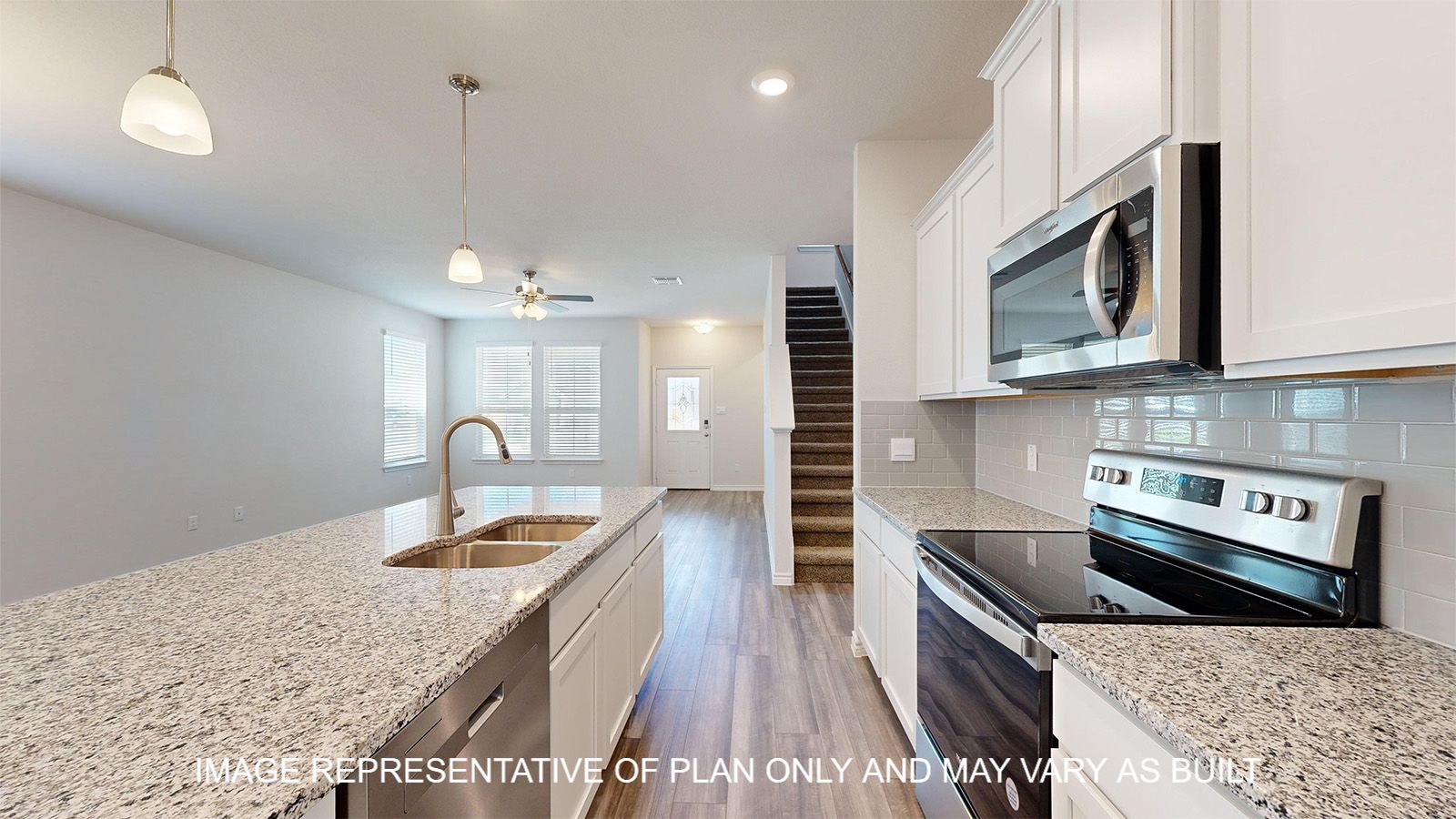 Sterling kitchen with white cabinets and granite countertops with stainless appliances.