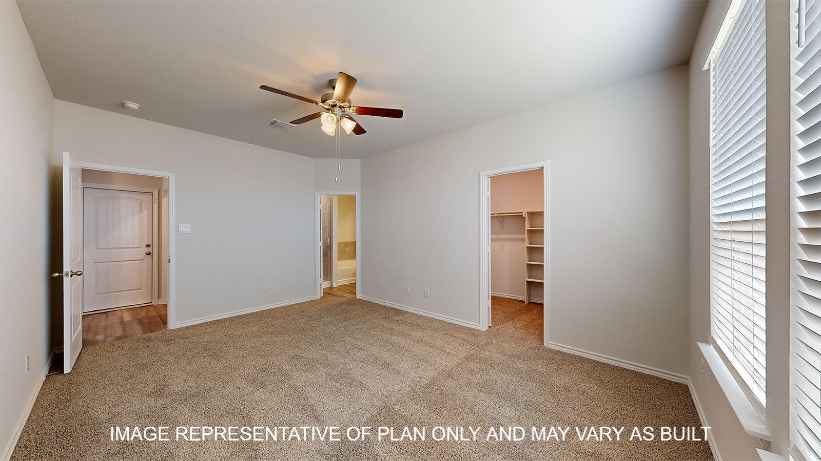 Sterling primary bedroom with carpet flooring with view of walk-in closet.