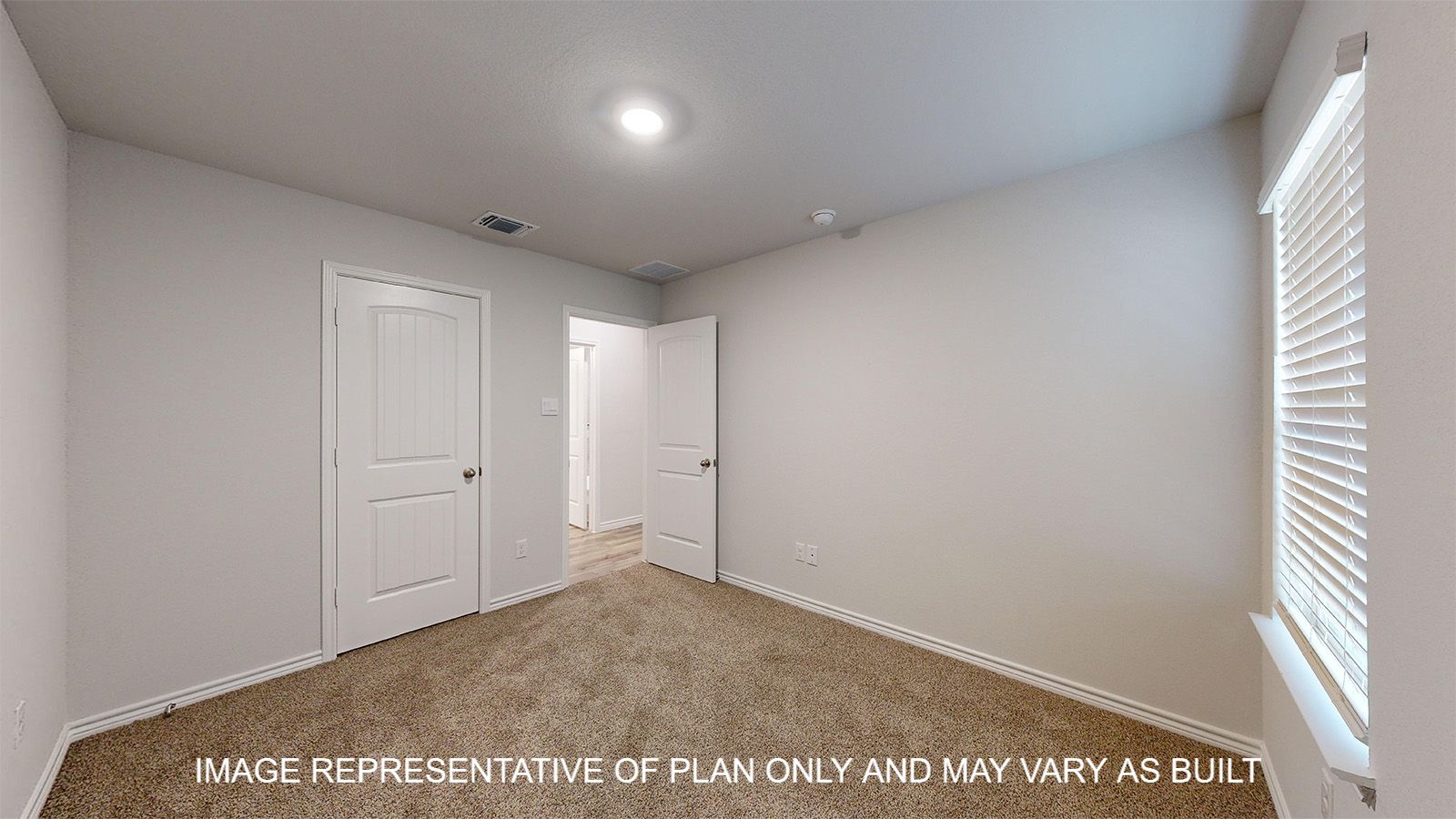 Everett secondary bedroom with carpet flooring and closet door.
