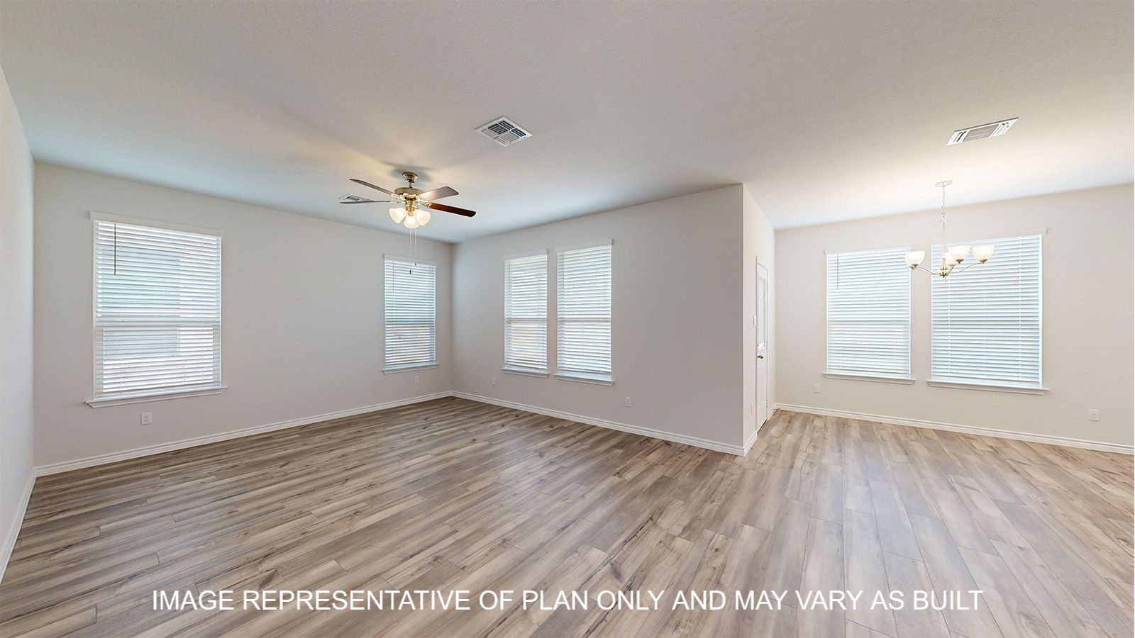 Magnolia living and dining room with vinyl plank flooring and windows for natural light.