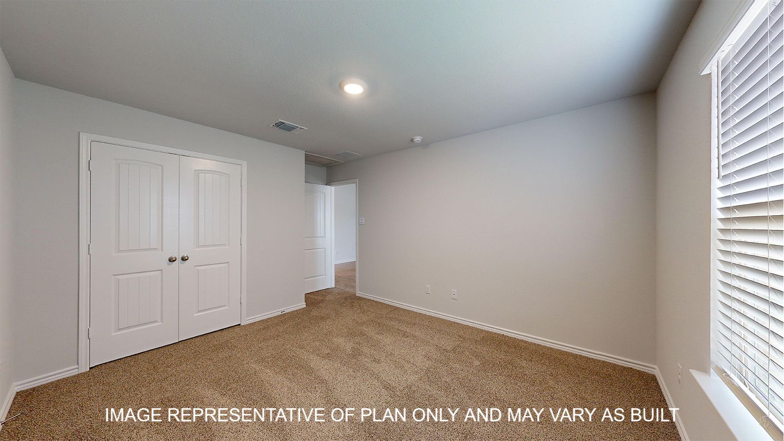 Magnolia secondary bedroom with carpet flooring and closet doors.