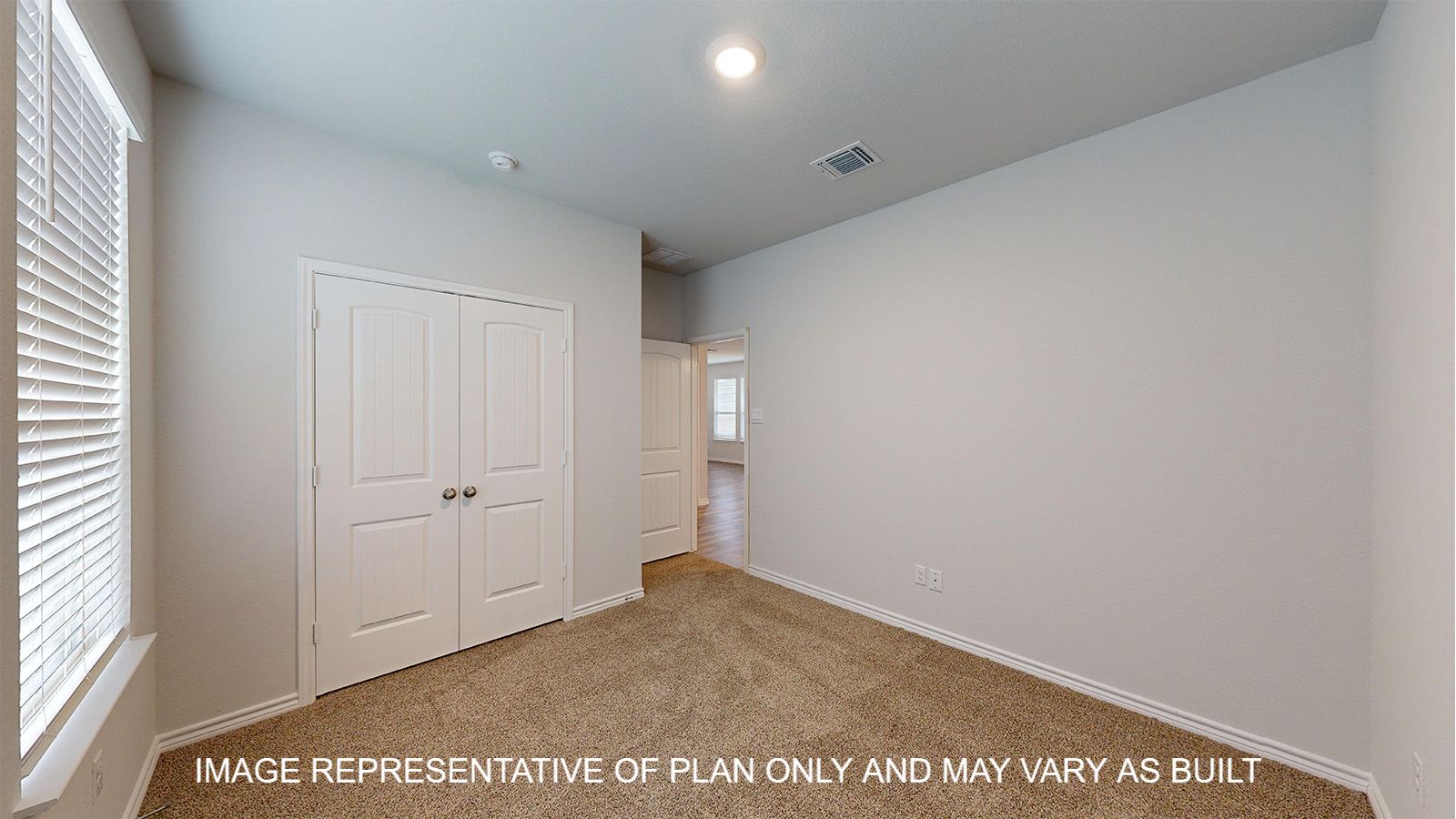 Magnolia secondary bedroom with carpet flooring and closet doors.