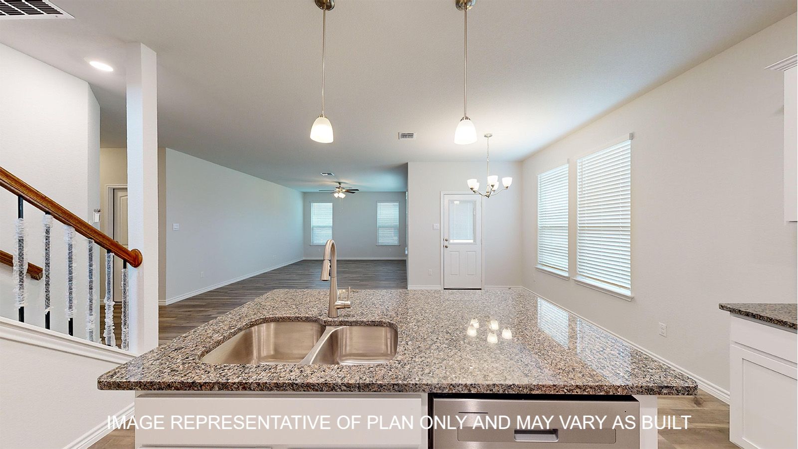 Magnolia kitchen with granite countertops and pendant lights above kitchen island.