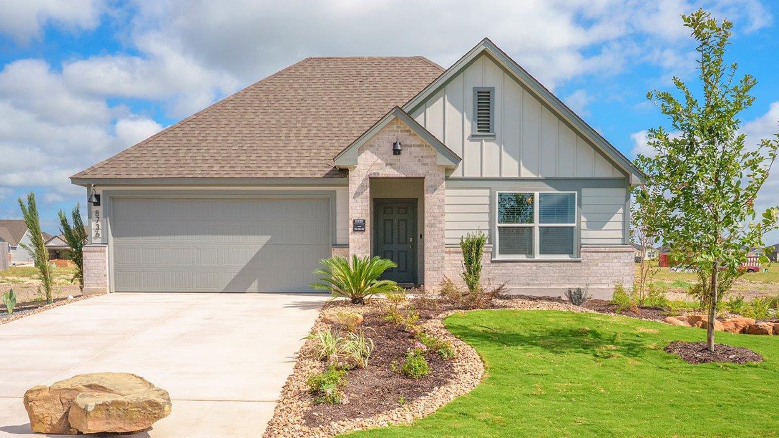 Mesa Ridge model home front exterior elevation with community sign.