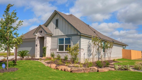 Mesa Ridge model home front exterior elevation with community sign.