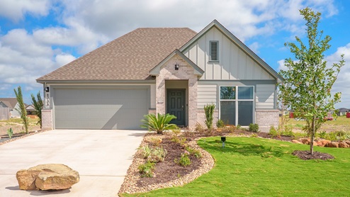 Mesa Ridge model home front exterior elevation with community sign.