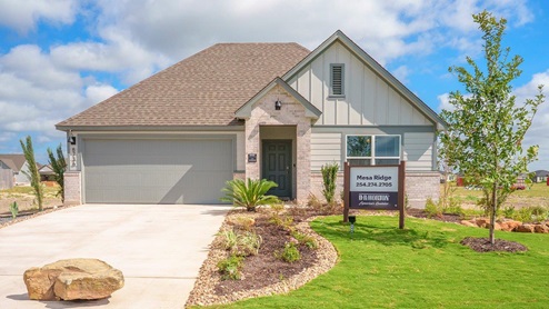 Mesa Ridge model home front exterior elevation with community sign.