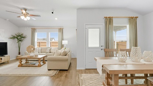 Mesa Ridge model home common with view of open concept dining room and living room.