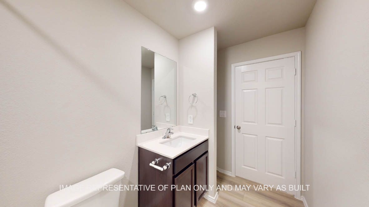 Camden secondary bathroom with dark cabinets and white countertops and vinyl flooring.