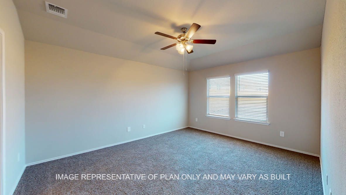 Texas Cali primary bedroom with carpet flooring and windows.