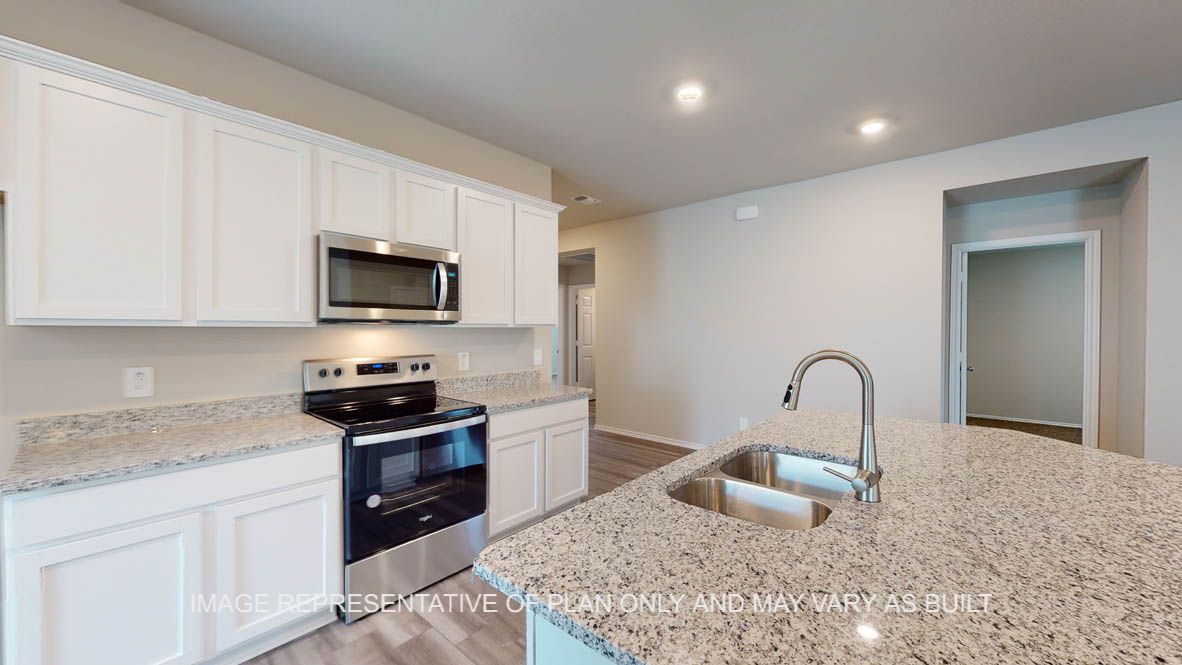 Kingston kitchen with white cabinets and granite countertops.