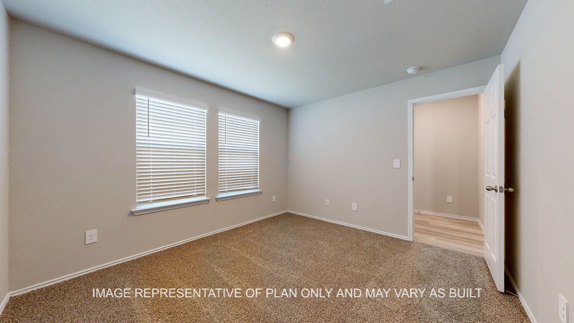 Seabrook secondary bedroom with carpet flooring and windows.