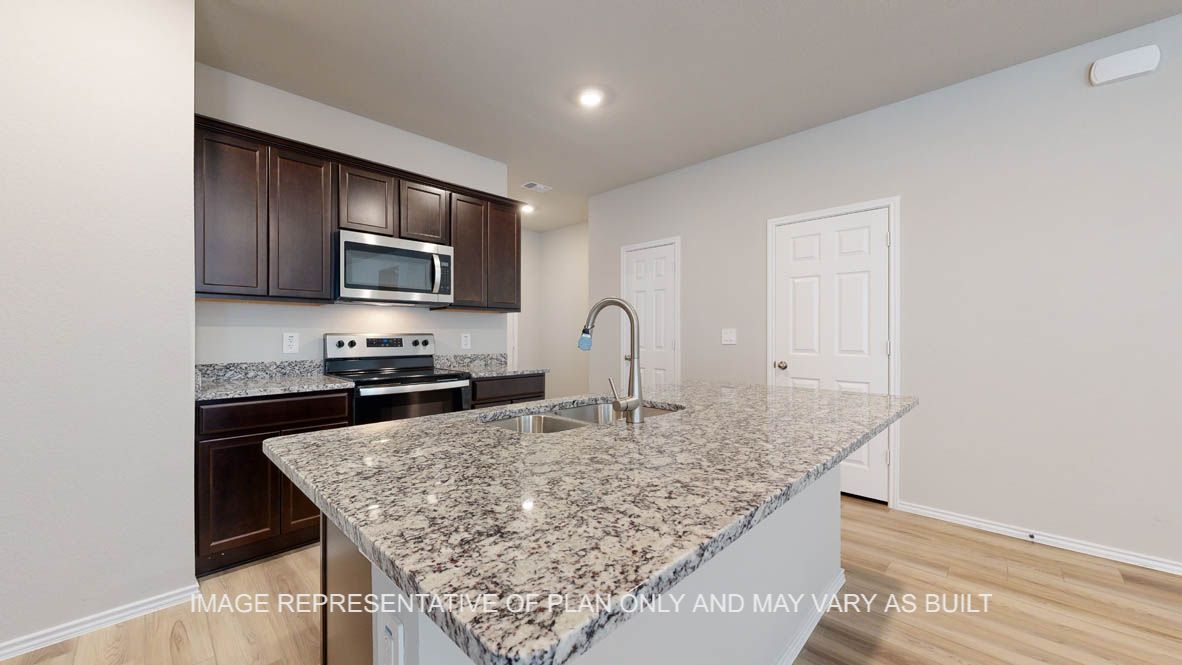Seabrook kitchen with dark cabinets and granite countertops.