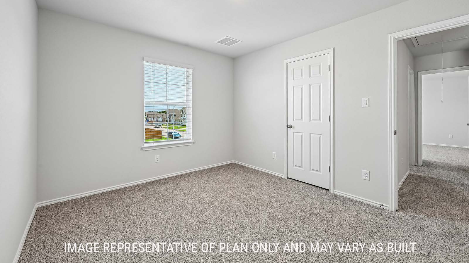 Madison secondary bedroom with carpeted flooring and window for natural lighting.